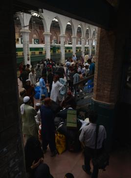 Pakistani passengers gather at a railway station as they prepare to return to their home towns ahead of the Eid al-Fitr festival in Lahore on July 3, 2016. (AFP) 