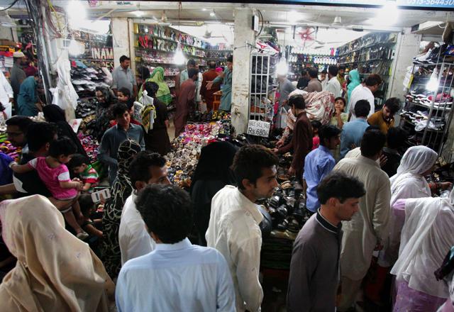 Pakistani families visit a market to buy clothes, shoes and other goods for the upcoming Eid al-Fitr holiday that marks the end of the Islamic fasting month of Ramadan, in Islamabad, Pakistan, Sunday, July 3, 2016.  (AP) 