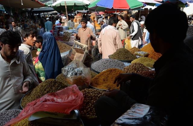Afghan residents buy dry fruits and sweet for the upcoming Eid Al-Fitr festivities at a local market in Jalalabad on July 3, 2016.  (AFP) 