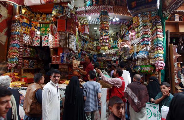 Yemeni shop owners sell sweets in the capital Sanaa on July 3, 2016, ahead of the Muslim holiday of Eid al-Fitr marking the end of the holy fasting month of Ramadan. (AFP) 