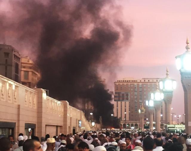 In this photo provided by Noor Punasiya, people stand by an explosion site in Medina, Saudi Arabia, Monday, July 4, 2016. State-linked Saudi news websites reported an explosion Monday near one of Islam's holiest sites in the city of Medina, as two suicide bombers struck in different cities. (AP)