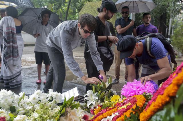 People offer flowers to pay their respects to the victims of the attack on Holey Artisan Bakery, in Dhaka on July 5. (AP) People offer flowers to pay their respects to the victims of the attack on Holey Artisan Bakery, in Dhaka on July 5. (AP)