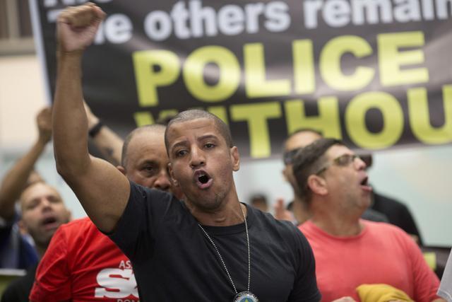 A police officer shouts slogans during a protest, demanding payments and better labour conditions, at the Tom Jobim International Airport, in Rio de Janeiro. (AP Photo) A police officer shouts slogans during a protest, demanding payments and better labour conditions, at the Tom Jobim International Airport, in Rio de Janeiro. (AP Photo)