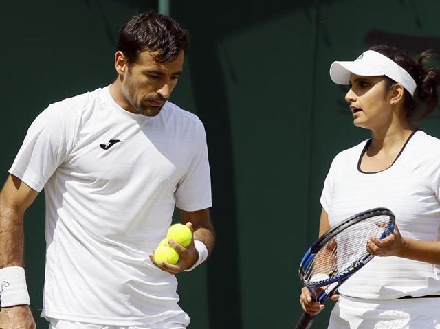 Sania Mirza speaks to partner Ivan Dodig during their mixed doubles match. (AP)