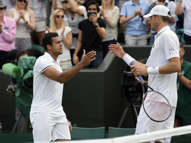 Jo-Wilfried Tsonga of France (left) shakes hands with John Isner of the US after beating him in their men's singles match. (AP Photo) Jo-Wilfried Tsonga of France (left) shakes hands with John Isner of the US after beating him in their men's singles match. (AP Photo)
