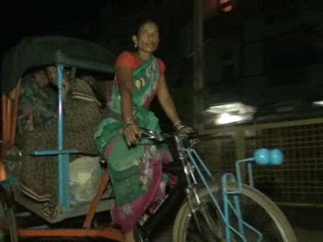 Guddi Bai driving a cycle rickshaw to take her pregnant neighbour Kanta Mehra to district hospital. Guddi Bai driving a cycle rickshaw to take her pregnant neighbour Kanta Mehra to district hospital.