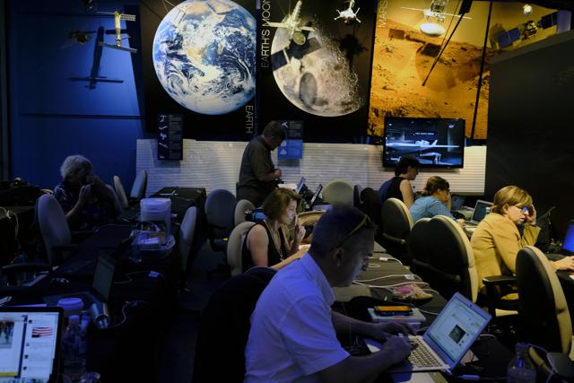 Journalists work in preparation for NASA's Juno spacecraft's orbit around Jupiter in the media center at Jet Propulsion Laboratory, in Pasadena. The spacecraft fired its main rocket engine late Monday to slow itself down from a speed of 250,000 kph and slip into orbit around Jupiter. The solar-powered spacecraft is spinning toward Jupiter for the closest encounter with the biggest planet in our solar system. (AP) Journalists work in preparation for NASA's Juno spacecraft's orbit around Jupiter in the media center at Jet Propulsion Laboratory, in Pasadena. The spacecraft fired its main rocket engine late Monday to slow itself down from a speed of 250,000 kph and slip into orbit around Jupiter. The solar-powered spacecraft is spinning toward Jupiter for the closest encounter with the biggest planet in our solar system. (AP)