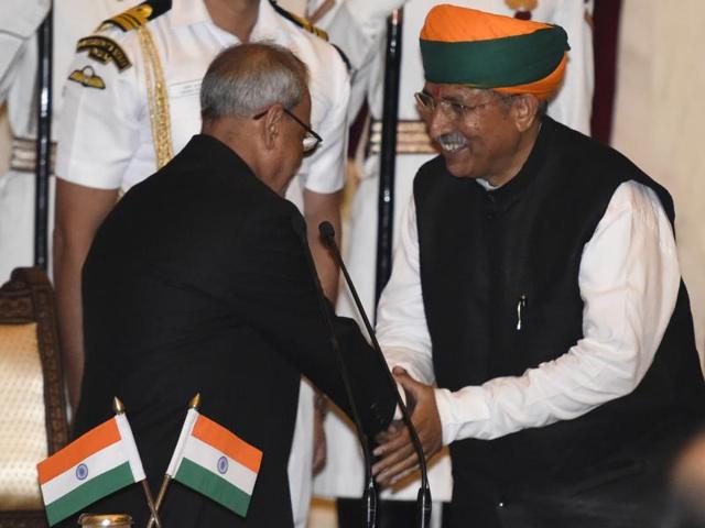 BJP MP Arjun Ram Meghwal shakes hand with President Pranab Mukherjee during the swearing-in ceremony of new ministers following Prime Minister Narendra Modi's cabinet reshuffle. (Sonu Mehta/ HT Photo) BJP MP Arjun Ram Meghwal shakes hand with President Pranab Mukherjee during the swearing-in ceremony of new ministers following Prime Minister Narendra Modi's cabinet reshuffle. (Sonu Mehta/ HT Photo)
