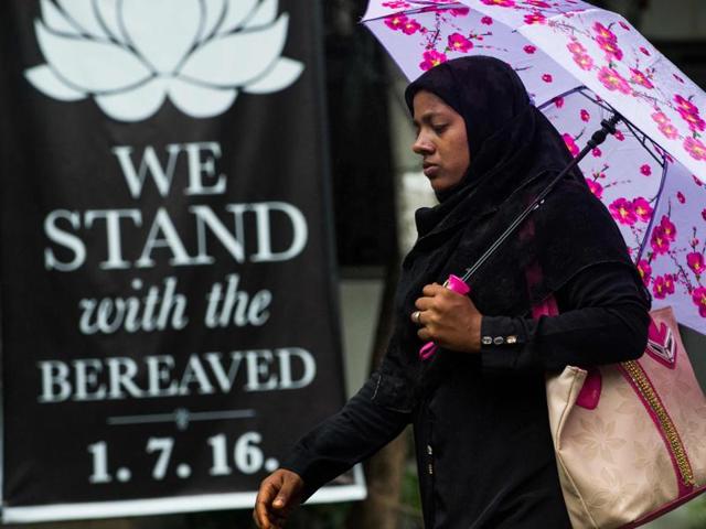 A Bangladeshi woman walks past a banner that reads "We stand with the bereaved" in a street near an upscale restaurant which was the site of a bloody siege that ended in the death of seventeen dead foreigners and five Bangladeshis, including two policemen, in Dhaka.(AFP) A Bangladeshi woman walks past a banner that reads "We stand with the bereaved" in a street near an upscale restaurant which was the site of a bloody siege that ended in the death of seventeen dead foreigners and five Bangladeshis, including two policemen, in Dhaka.(AFP)