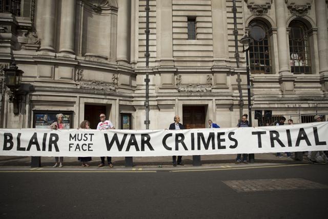 Protesters hold up a large banner outside the Queen Elizabeth II Conference Centre in London, shortly before the publication of the Chilcot report into the Iraq war. (AP Photo) Protesters hold up a large banner outside the Queen Elizabeth II Conference Centre in London, shortly before the publication of the Chilcot report into the Iraq war. (AP Photo)
