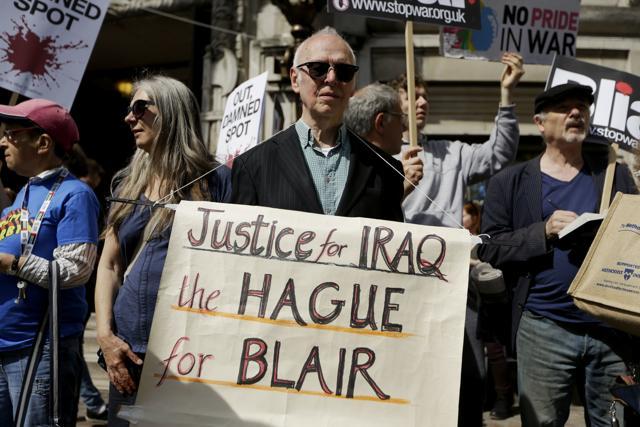 A protester holds a placard outside the Queen Elizabeth II Conference Centre in London, shortly before the publication of the Chilcot report into the Iraq war. (AP Photo) A protester holds a placard outside the Queen Elizabeth II Conference Centre in London, shortly before the publication of the Chilcot report into the Iraq war. (AP Photo)