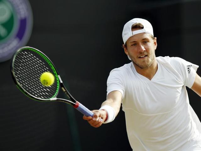 Lucas Pouille returns serve to Tomas Berdych. (AP)