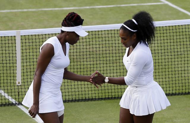 After their respective quarterfinal wins, Venus and Serena Williams teamed up to play doubles. Venus and Serena are on course to meet in the singles final. (AP)