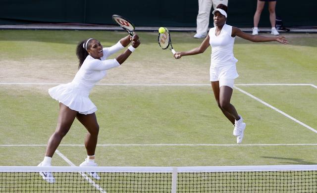 Venus Williams (left) and Serena Williams return to Andrea Hlavackova and Lucie Hradecka during their match. (AP Photo) Venus Williams (left) and Serena Williams return to Andrea Hlavackova and Lucie Hradecka during their match. (AP Photo)