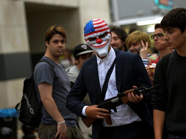 A person wearing a mask walks during the parade. (REUTERS) A person wearing a mask walks during the parade. (REUTERS)