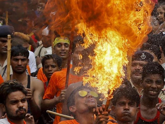 An man performs a fire act during the annual festival of Rath Yatra of Lord Jagannath in Ahmadabad. (Ajit Solanki/AP Photo)