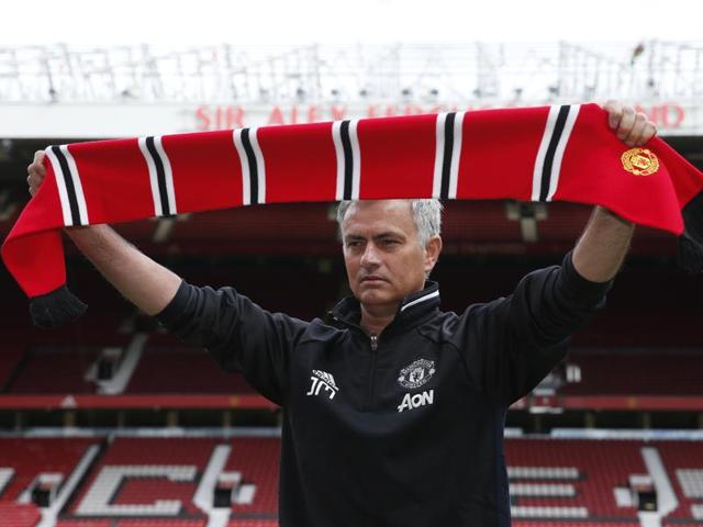 Manchester United's new Portuguese manager Jose Mourinho poses with a scarf on the pitch during a photocall at Old Trafford stadium in Manchester, northern England. (AFP Photo) Manchester United's new Portuguese manager Jose Mourinho poses with a scarf on the pitch during a photocall at Old Trafford stadium in Manchester, northern England. (AFP Photo)