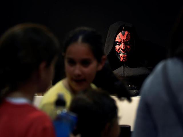 People visit a Star Wars exhibition at the Metropoli on July 1, 2016 as a cosplayer glowers behind. (REUTERS) People visit a Star Wars exhibition at the Metropoli on July 1, 2016 as a cosplayer glowers behind. (REUTERS)