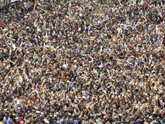 Thousands of devotees raise their hands on the first sight of Lord Jagannath’s chariot during Ratahyatra festival in Puri. (Arabinda Mahapatra /HT photo)