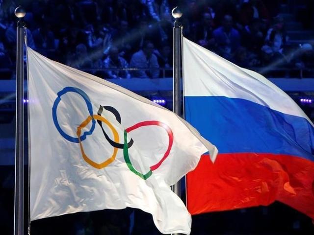 The Russian national flag (right) and the Olympic flag are seen during the closing ceremony during the 2014 Sochi Winter Olympics, Russia. (Reuters File Photo) The Russian national flag (right) and the Olympic flag are seen during the closing ceremony during the 2014 Sochi Winter Olympics, Russia. (Reuters File Photo)