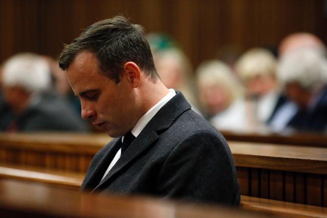Paralympian athlete Oscar Pistorius (left), accused of the murder of his girlfriend Reeva Steenkamp three years ago, looks on during the hearing in his murder trail at the high court in Pretoria. (AFP Photo)