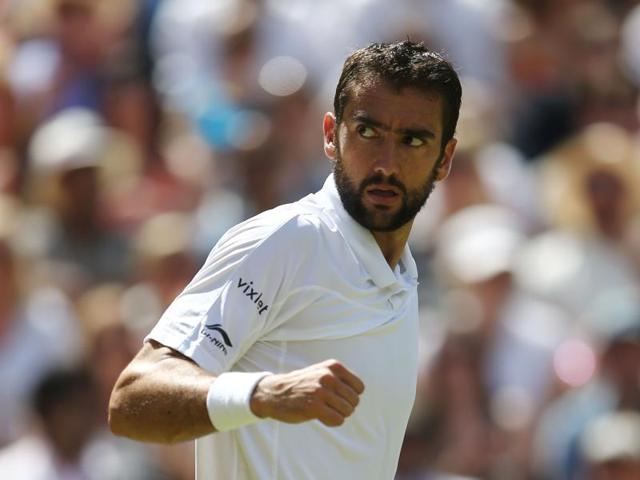 Cilic celebrates winning the second set. (AFP)