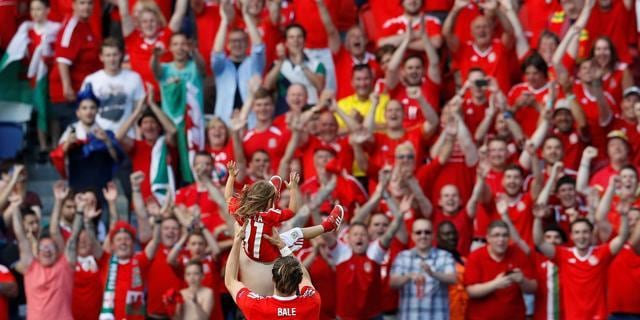 Wales' Gareth Bale celebrates with daughter Alba and fans at the end of their match against Northern Ireland. (Reuters Photo) Wales' Gareth Bale celebrates with daughter Alba and fans at the end of their match against Northern Ireland. (Reuters Photo)