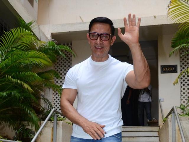 Aamir sports a casual look with a white T shirt and blue jeans. (Viral Bhayani)