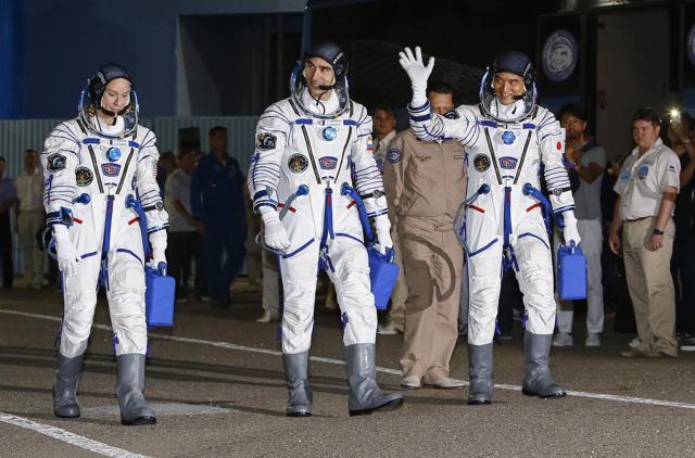 US astronaut Kate Rubins, left, Russian cosmonaut Anatoly Ivanishin, centre, and Japanese astronaut Takuya Onishi, members of the main crew of the expedition to the International Space Station, walk to report to members of the State Committee prior to the launch of Soyuz MS space ship. (AP Photo) US astronaut Kate Rubins, left, Russian cosmonaut Anatoly Ivanishin, centre, and Japanese astronaut Takuya Onishi, members of the main crew of the expedition to the International Space Station, walk to report to members of the State Committee prior to the launch of Soyuz MS space ship. (AP Photo)