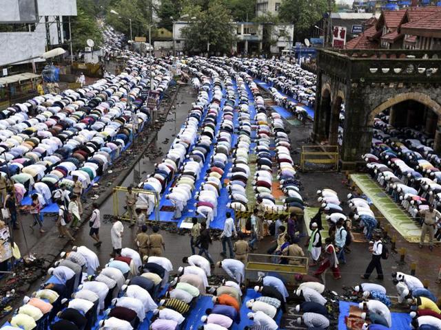 Muslims offer Eid-ul-Fitr prayers outside the Bandra station in Mumbai on Thursday. The Eid celebrations mark the culmination of the month-long fasting period. (Kunal Patil)
