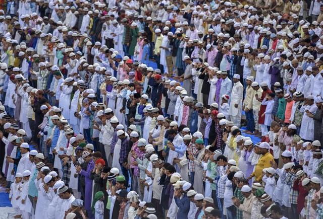 Faithfuls rise with bowed head in perfect synchronisation during Eid prayers outside the Bandra Station in Mumbai on Thursday. (Kunal Patil)