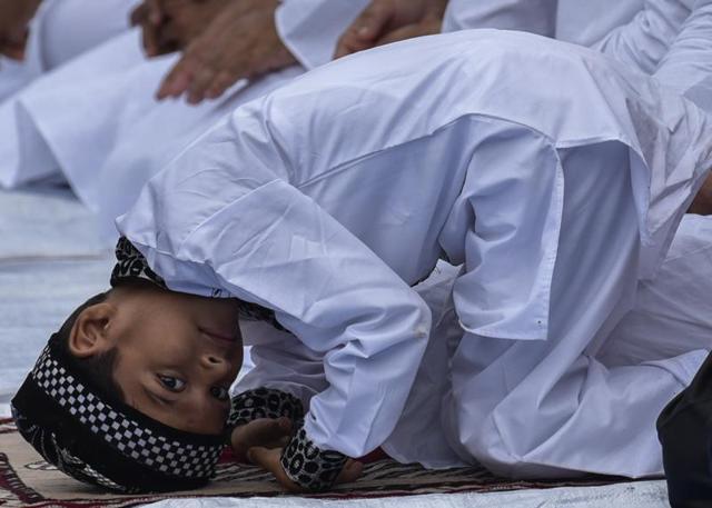A child looks on during Eid al-Fitr prayers outside Bandra Station in Mumbai on Thursday. (Kunal Patil)
