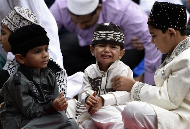 Children react after the Eid-ul-Fitr prayers at the Bandra Station in Mumbai on Thursday. (Kunal Patil)
