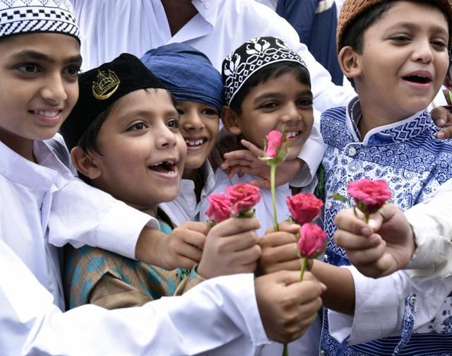 Children celebrate Eid by offering flowers to each other at the Bandra station in Mumbai on Thursday. (Kunal Patil)