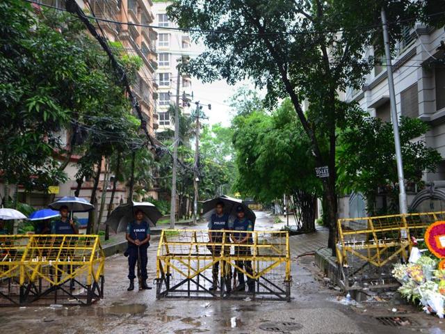 Policemen stand under umbrellas at a checkpoint in Dhaka. (AFP) Policemen stand under umbrellas at a checkpoint in Dhaka. (AFP)
