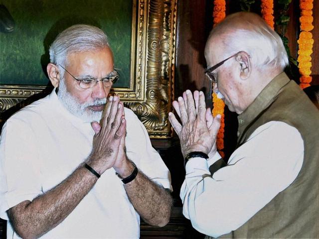 Prime Minister Narendra Modi and senior BJP leader LK Advani in New Delhi on Wednesday. (PTI Photo) Prime Minister Narendra Modi and senior BJP leader LK Advani in New Delhi on Wednesday. (PTI Photo)