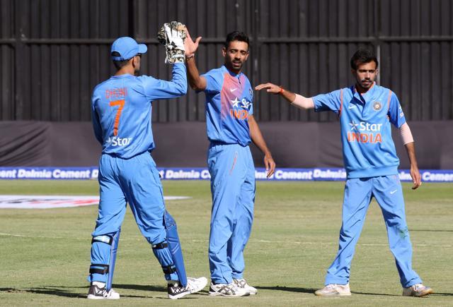 Dhawal Kulkarni is congratulated by teammates MS Dhoni and Yuzvendra Chahal after taking a wicket in their match against Zimbabwe. (Reuters Photo)