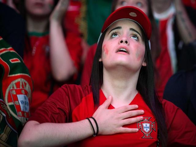 A Portugal supporter reacts as she watches, on a giant screen, the Euro 2016 semifinal football match between Portugal and Wales at the fan zone of the Champ de Mars in Paris. (AFP Photo) A Portugal supporter reacts as she watches, on a giant screen, the Euro 2016 semifinal football match between Portugal and Wales at the fan zone of the Champ de Mars in Paris. (AFP Photo)