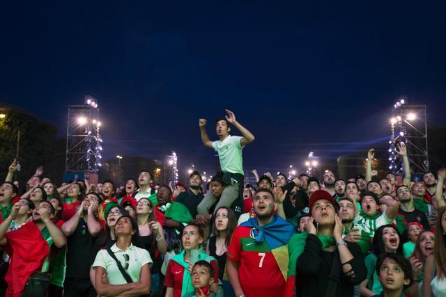 Portugal's supporters react as they watch the Euro 2016 semifinal football match between Portugal and Wales at the fan zone of the Champ de Mars in Paris. (AFP Photo) Portugal's supporters react as they watch the Euro 2016 semifinal football match between Portugal and Wales at the fan zone of the Champ de Mars in Paris. (AFP Photo)
