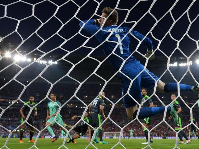 Wales' goalkeeper Wayne Hennessey (right) takes the first goal scored by Portugal's forward Cristiano Ronaldo (left). (AFP Photo) Wales' goalkeeper Wayne Hennessey (right) takes the first goal scored by Portugal's forward Cristiano Ronaldo (left). (AFP Photo)