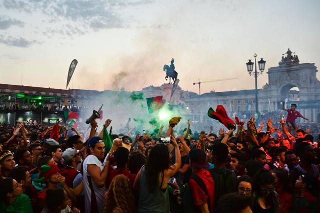 Portugal football team's supporters react to the first goal as they watch the Euro 2016 semifinal football match against Wales, displayed on a giant screen at Terreiro do Paco square in Lisbon. (AFP Photo) Portugal football team's supporters react to the first goal as they watch the Euro 2016 semifinal football match against Wales, displayed on a giant screen at Terreiro do Paco square in Lisbon. (AFP Photo)
