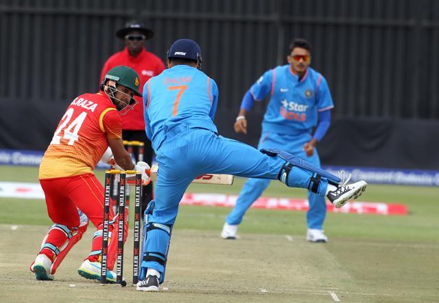 Zimbabwean batsman Sikandar Raza Butt (left) plays a shot as Indian wicketkeeper and captain MS Dhoni field, during the ODI cricket match between Zimbabwe and India, at the Harare Sports Club. (AP Photo)