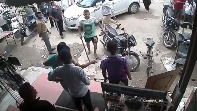 In the video, uploaded on Wednesday afternoon on Facebook, the buyer was first seen slapping the shop owner. Then a few minutes later, a group of armed men reached the spot on buyer’s phone call and badly assaulted the shop owner and his father with sticks and iron rods. (CCTV footage grab) In the video, uploaded on Wednesday afternoon on Facebook, the buyer was first seen slapping the shop owner. Then a few minutes later, a group of armed men reached the spot on buyer’s phone call and badly assaulted the shop owner and his father with sticks and iron rods. (CCTV footage grab)