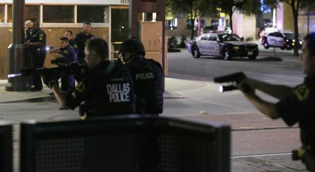 Police move to detain a driver after several police officers were shot in downtown Dallas (AP) Police move to detain a driver after several police officers were shot in downtown Dallas (AP)