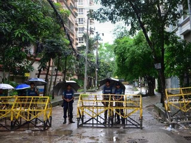 Bangladeshi policemen stand under umbrellas at a checkpoint in Dhaka on July 5, 2016, in a street leading to the entrance of a restaurant which was the site of a bloody siege that ended in the death 20 hostages. (AFP Photo) Bangladeshi policemen stand under umbrellas at a checkpoint in Dhaka on July 5, 2016, in a street leading to the entrance of a restaurant which was the site of a bloody siege that ended in the death 20 hostages. (AFP Photo)