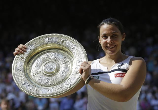 Marion Bartoli smiles as she holds the trophy after winning the Women's singles final match against Sabine Lisicki of Germany at the All England Lawn Tennis Championships in Wimbledon, London. T (AP File Photo) Marion Bartoli smiles as she holds the trophy after winning the Women's singles final match against Sabine Lisicki of Germany at the All England Lawn Tennis Championships in Wimbledon, London. T (AP File Photo)