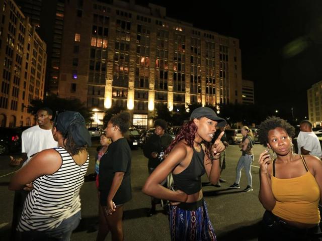 Dallas residents stand near the scene where four Dallas police officers were shot and killed on Thursday. (AFP Photo) Dallas residents stand near the scene where four Dallas police officers were shot and killed on Thursday. (AFP Photo)