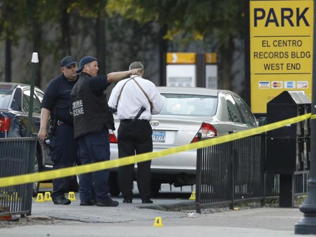 Crime scene investigators survey an area after a shooting in downtown Dallas. (AP) Crime scene investigators survey an area after a shooting in downtown Dallas. (AP)