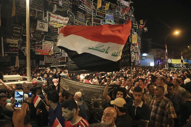 Iraqis gather at the scene of Sunday's truck bombing in the Karada neighborhood, Baghdad, Iraq,Thursday, July 7, 2016. The bombing, claimed by the Islamic State group, was the deadliest terror attack in Iraq in a year and one of the worst single bombings in more than a decade of war and insurgency. (AP)