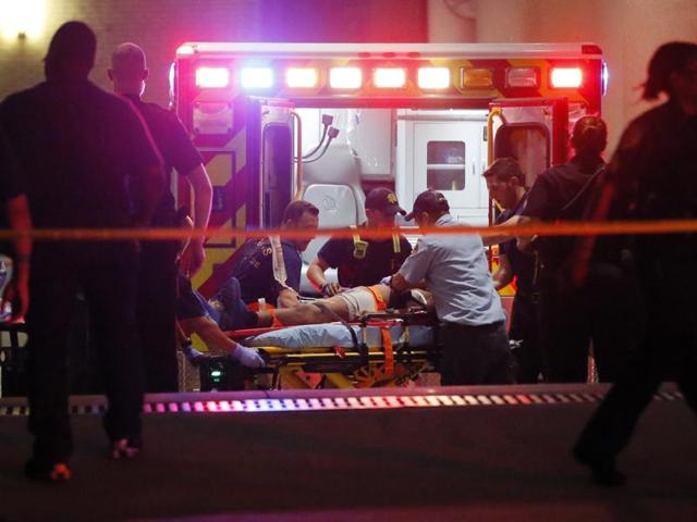 Emergency responders administer CPR to an unknown patient on a stretcher as law enforcement officials stand nearby at the emergency receiving area of Baylor University Medical Center. (AP)